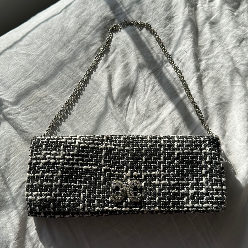 Ladies clutch or can be used with strap. Made  by Cache.